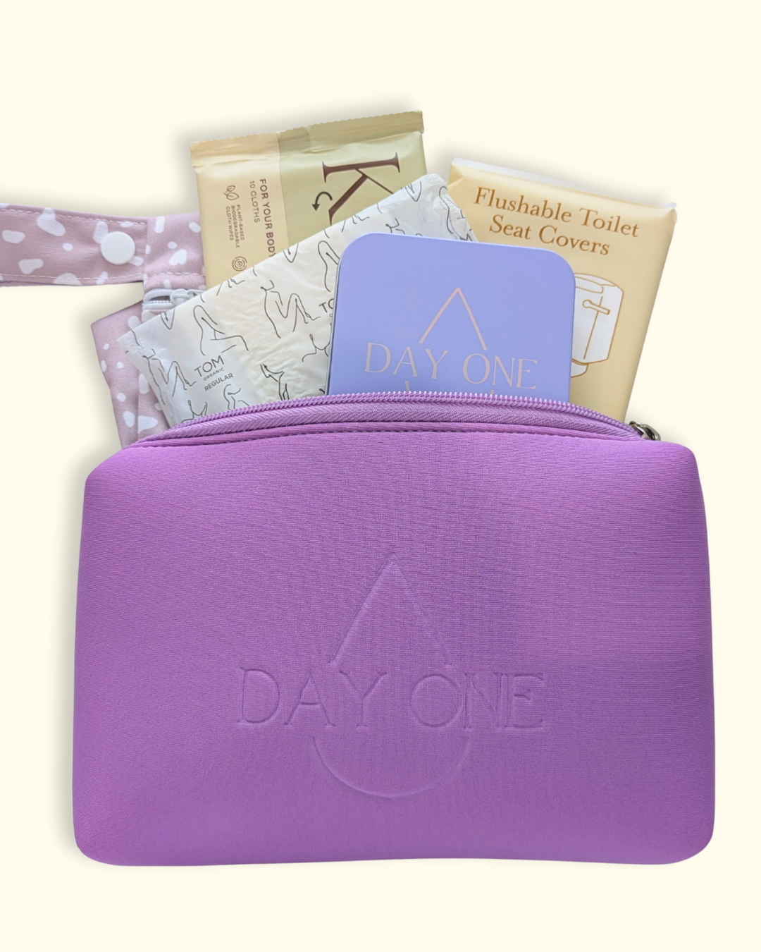 purple period kit for girls with all the inclusions such as: pill storage tin, flushable toilet seat covers, flushable wipes, reusable wet bag, and menstrual pads. perfect period kit for girls.