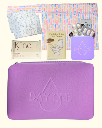 purple period kit lay flat with all the inclusions such as: pill storage tin, flushable toilet seat covers, flushable wipes, reusable wet bag, and menstrual pads. perfect period kit for girls.